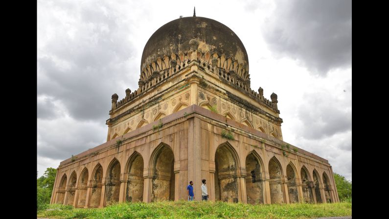 Visitors are dwarfed by the tomb of Sultan Muhammad Qutb Shah. The granite tombs have distinctive appearances, fusing elements of Persian, Hindu and Pathan architectural styles.  