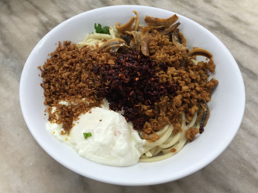 In Super Kitchen's chili pan mee, soft, chewy noodles are topped with fried anchovy, deep fried onions, fresh scallions, crushed peanuts, shredded pork and a poached egg.