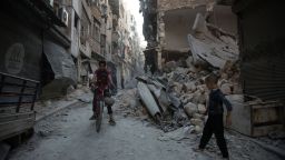TOPSHOT - Syrians walk through the rubble following an airstrike on the regime-controlled neighbourdhood of Karm al-Jabal on September 18, 2016.


Syria's ceasefire was on the brink of collapsing Sunday, after a US-led coalition strike killed dozens of regime soldiers and Aleppo city was hit by its first raids in nearly a week.


 / AFP / KARAM AL-MASRI        (Photo credit should read KARAM AL-MASRI/AFP/Getty Images)
