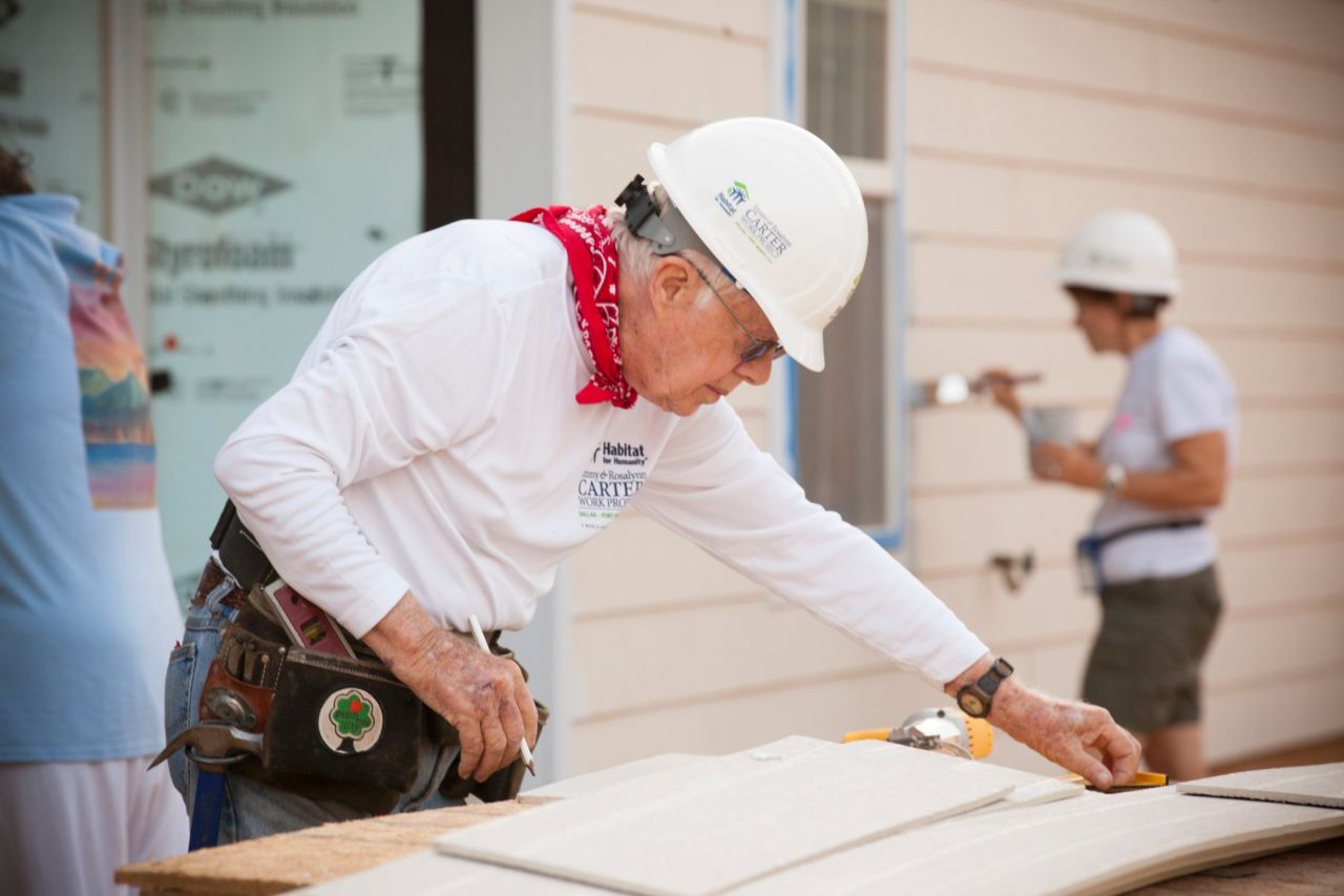 Jimmy Carter helps install siding on a new home during the 2014 Jimmy & Rosalynn Carter Work Project in Fort Worth, Texas.