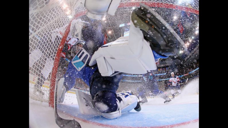 Team Europe goalie Jaroslav Halak is bumped by a member of Team USA during their World Cup opener on Saturday, September 17. Halak shut out the Americans 3-0.