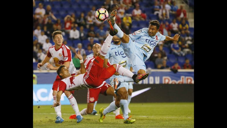 Alianza's Danny Torres, right, defends a bicycle kick by New York Red Bulls midfielder Gonzalo Veron during a CONCACAF Champions League match on Thursday, September 15.