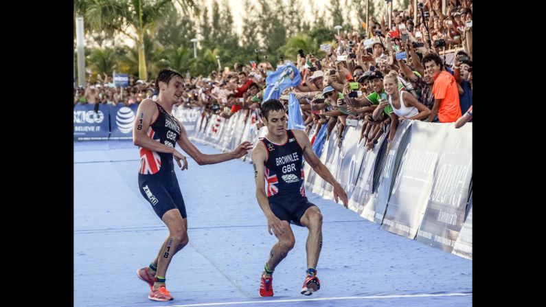 British athlete Alistair Brownlee, left, <a href="index.php?page=&url=http%3A%2F%2Fwww.cnn.com%2F2016%2F09%2F19%2Fsport%2Falistair-brownlee-jonny-brownlee-world-triathlon-series%2F" target="_blank">helps his brother Jonny cross the finish line</a> at the World Triathlon Championships on Sunday, September 18. Jonny was leading the field coming into the final straight, but exhaustion rapidly set in during a hot day in Cozumel, Mexico. When he was at the point of collapse, his brother arrived on the scene. They finished together, with Jonny in second and Alistair in third. Jonny collapsed to the ground immediately and required medical attention. He later tweeted from a hospital bed that he was fine. Last month, the brothers finished 1-2 in the Olympic triathlon. Alistair won gold for the second straight Olympics.