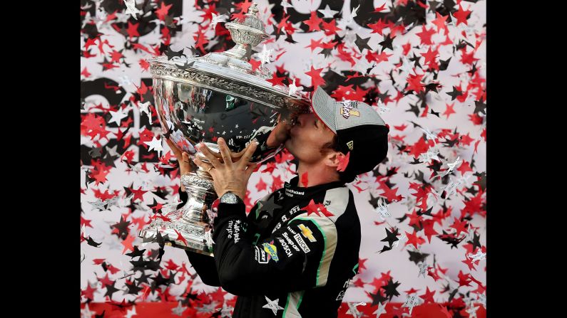 Simon Pagenaud kisses his trophy after clinching the IndyCar title in Sonoma, California, on Sunday, September 18. It is his first IndyCar championship.