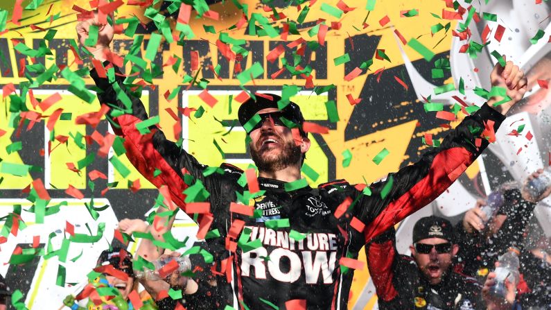 NASCAR driver Martin Truex Jr. celebrates after winning a Sprint Cup race at Chicagoland Speedway on Sunday, September 18. It was the first race of this season's Chase for the Cup.