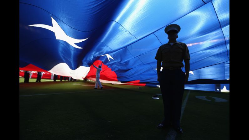 A U.S. Marine stands at attention under a large American flag before an NFL game in San Diego on Sunday, September 18. <a href="index.php?page=&url=http%3A%2F%2Fwww.cnn.com%2F2016%2F09%2F12%2Fsport%2Fgallery%2Fwhat-a-shot-sports-0913%2Findex.html" target="_blank">See 34 amazing sports photos from last week</a>