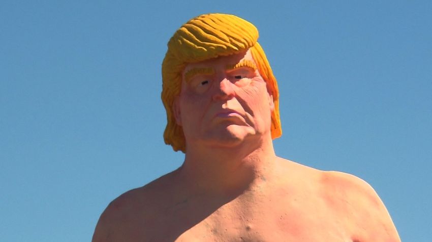 Who stole Naked Trump? Jeanne Moos has surveillance video of the thief who stole a naked statue.    Who Stole Naked Trump   The Naked Trump statue that went up last week near the entrance to NYC's Holland Tunnel was stolen in the wee hours of Monday morning...and we have (exclusive!) surveillance video of the thief creeping across the roof and even covering up the camera lens with a plastic bag. The perp spent about 3 and a half hours up there before managing to bring down the lightweight statue. And at the same moment he descended, a police car is seen on the surveillance vid entering the lot...which led the property owner to wonder if police were in on it or were simply answering a burglary call triggered by the thief. The National Fraternal Order of Police has endorsed trump. Since then no sign of the Donald's statue. Where is Naked Trump?