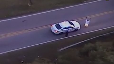 Video from a police helicopter circling above shows Terence Crutcher with his hands up as an officer approaches him.