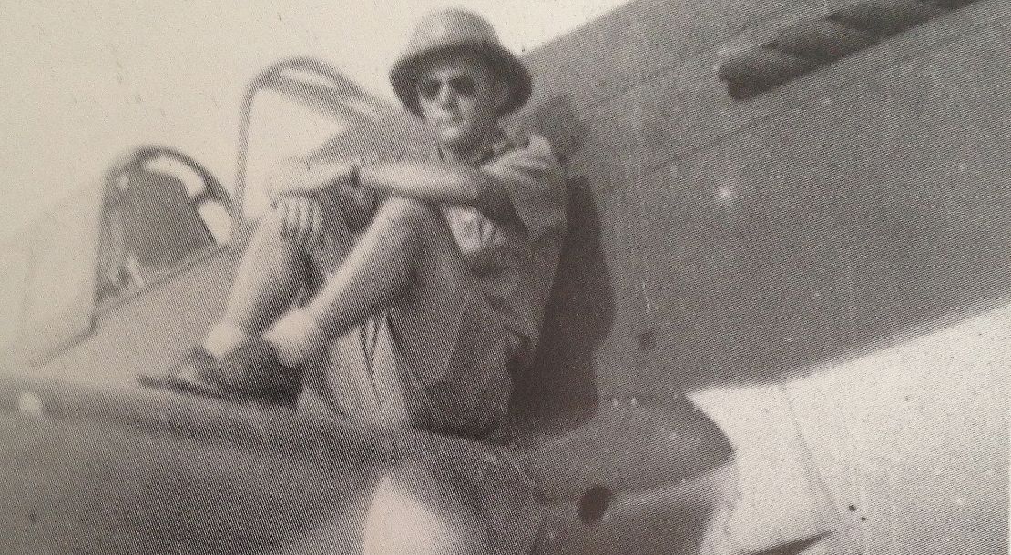 Flying Tiger crew chief Frank Losonsky sits on the wing of a P-40 Warhawk fighter plane in 1942.
