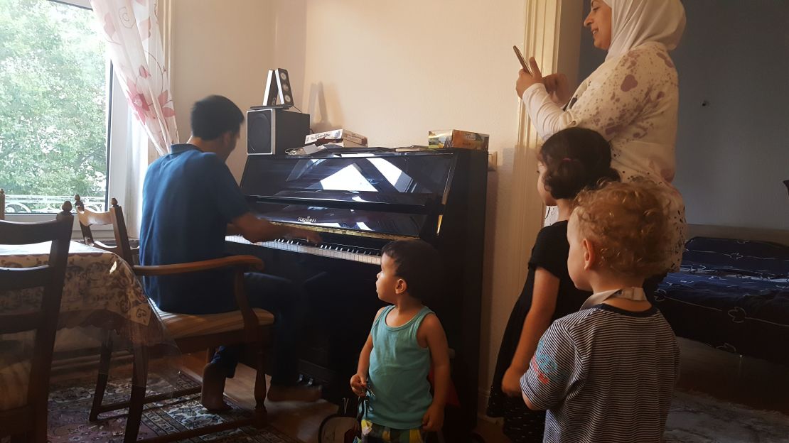 Aeham plays for his neighbours and kids at his new home in Wiesbaden, Germany.