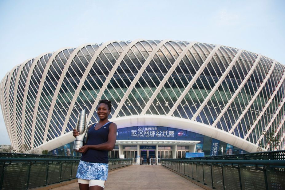Venus Williams posing with the Wuhan Open trophy, the 47th singles title of her career,  in front of the stadium after she beat Spain's Garbine Muguruza in last year's final.  
