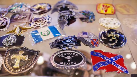 Belt buckles inside a display case at an Albertville gift shop show the city's changing demographics.