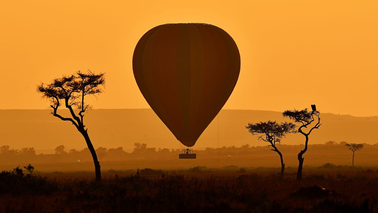 Three awesome experiences in one photo: A hot air balloon ride. The stunning sweep of Kenya's Masai Mara game reserve. And the annual wildebeest migration. 