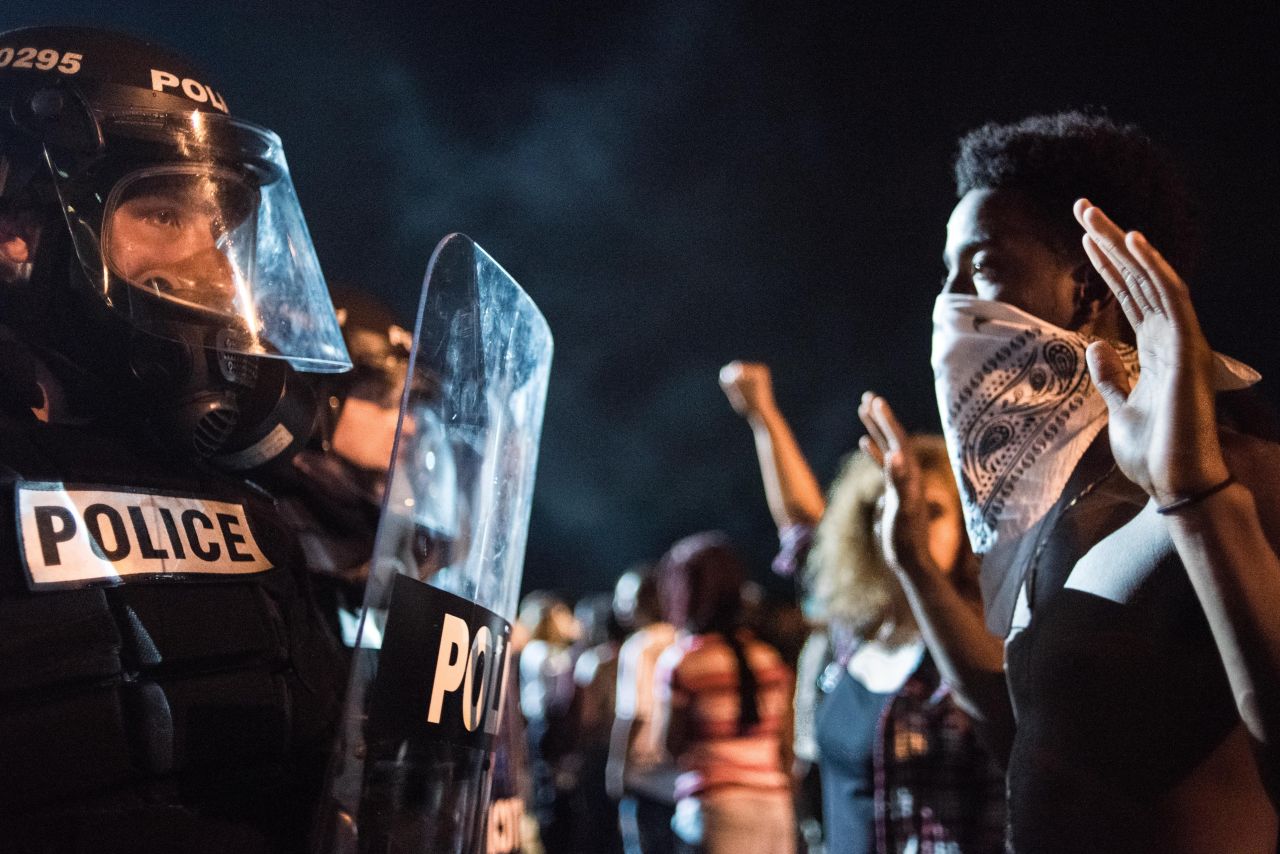 On the first night of demonstrations, police officers face off with protesters on Interstate 85.