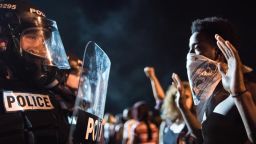 Police officers face off with protestors on Interstate 85 during protests following the death of a man shot by a police officer on Wednesday, September 21, in Charlotte, North Carolina. Violent protests erupted overnight following the fatal shooting of 43-year-old Keith Lamont Scott while trying to serve a warrant for a different man at an apartment complex.