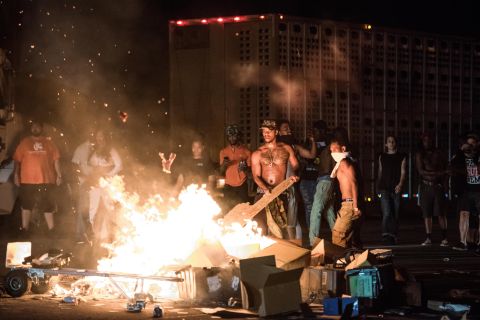 After blocking traffic on I-85, some of the protesters took cargo from tractor-trailers and set it on fire.