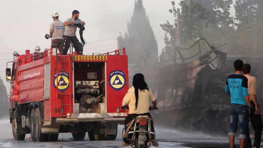 Members of the Syrian Civil Defence extinguish burning trucks carrying aid on the side of the road in the town of Orum al-Kubra on the western outskirts of the northern Syrian city of Aleppo on September 20, 2016, the morning after a convoy delivering aid was hit by a deadly air strike.
The UN said at least 18 trucks in the 31-vehicle convoy were destroyed en route to deliver humanitarian assistance to the hard-to-reach town.
/ AFP / Omar haj kadour (Photo credit should read OMAR HAJ KADOUR/AFP/Getty Images)