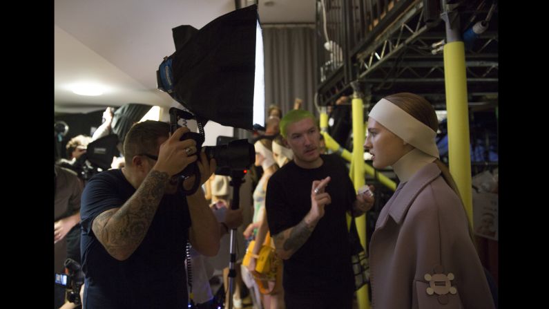 A photographer shoots a model backstage before the start of the Anya Hindmarch catwalk show. With multiple photographers vying for position in the pit, things can get competitive. "I've got to admit I lost my temper a bit at one of the shows, when I arrived and saw my spot had been half-taken by another photographer," says Isabel Infantes at her first London Fashion Week. "I panicked a bit but in the end we made peace."