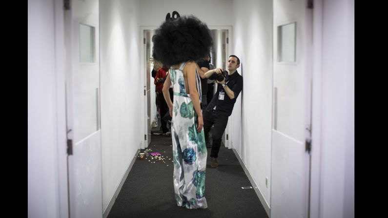 A photographer shoots backstage before the Vin & Omi catwalk show. "I shoot a lot of behind the scenes and backstage," says Price. "The way I like to shoot is to quickly slip into position [in the pit] just towards the very end." 