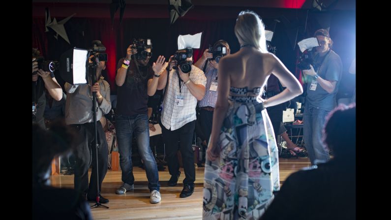 Celebrity photographers shoot arrivals of front row guests before the Vin & Omi catwalk show on September 19. "I once saw a fantastic fight in Milan," Moore recalls. "Some French guy had nicked some Italian guy's spot. Everyone was on their boxes and they started to have a proper tear-up. One of them hit the other one and literally half the photographers went down like a house of cards."