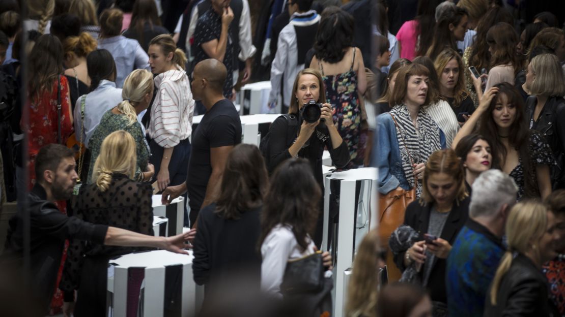 Suzanne Plunkett (center) takes a self portrait in a reflection at the end of the runway.