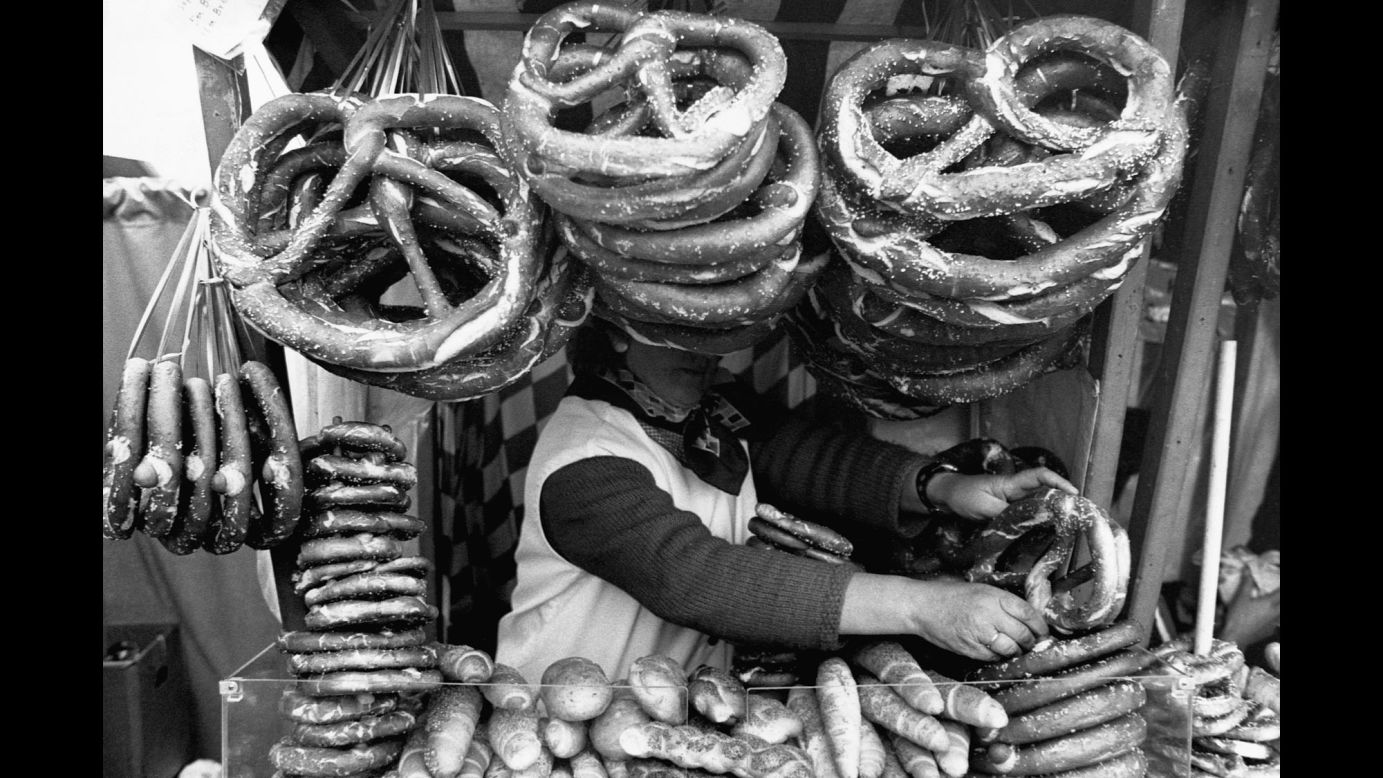 Massive pretzels obscure a food vendor's face in Munich.