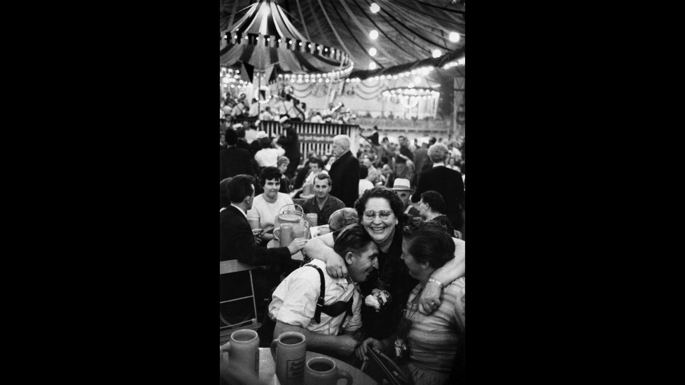A woman hugs two people at Oktoberfest in 1961.