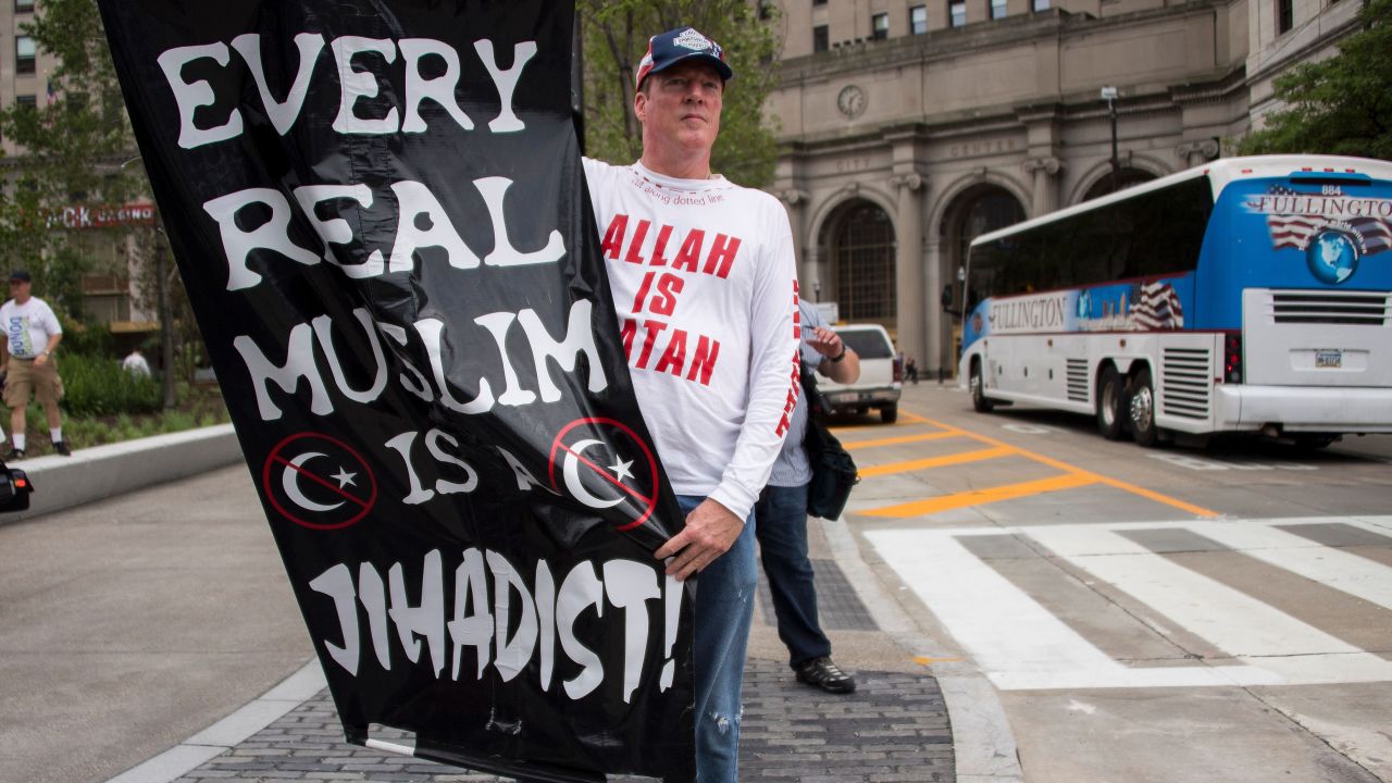 A Donald Trump supporter holds up an anti-Muslim poster near the Republican National Convention in Cleveland in July.