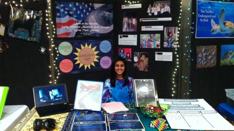 Aleena Khan presents her research on Muslim American teenagers at a Maryland school fair.