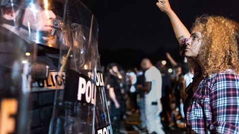 CHARLOTTE, NC - SEPTEMBER 21: Police officers face off with protestors on the I-85 (Interstate 85) during protests following the death of a man shot by a police officer on September 21, 2016 in Charlotte, NC. The protests began the previous night following the fatal shooting of 43-year-old Keith Lamont Scott at an apartment complex near UNC Charlotte. (Photo by Sean Rayford/Getty Images)