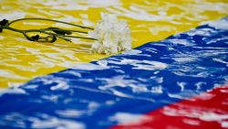 A flower remains on a Colombian national flag during a march along the streets of Cali, Colombia, on July 15, 2016, in support of the peace talks between the government of Colombian President Juan Manuel Santos and the FARC guerrillas, which takes place in Havana, Cuba. 
Different social organizations held rallies in cities across the country Friday in the framework of a campaign to support the peace process. / AFP / LUIS ROBAYO        (Photo credit should read LUIS ROBAYO/AFP/Getty Images)