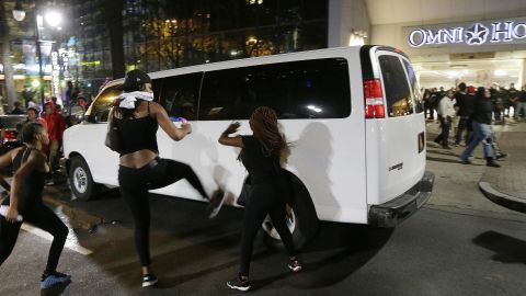 Protesters rushed police in riot gear at a downtown Charlotte hotel. Officers fired tear gas to disperse the crowd.