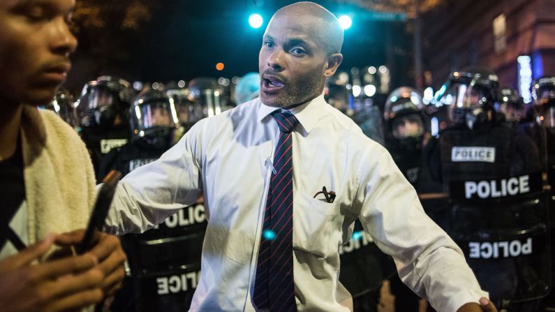 Charlotte public defender Toussaint Romain pushes a protester back from a line of police. "We can't lose any more lives, man. I'm a public defender. I can't represent any more people," <a href="index.php?page=&url=http%3A%2F%2Fwww.cnn.com%2F2016%2F09%2F21%2Fus%2Fpublic-defender-toussaint-romain-charlotte-protests%2Findex.html" target="_blank">he told CNN's Boris Sanchez.</a>