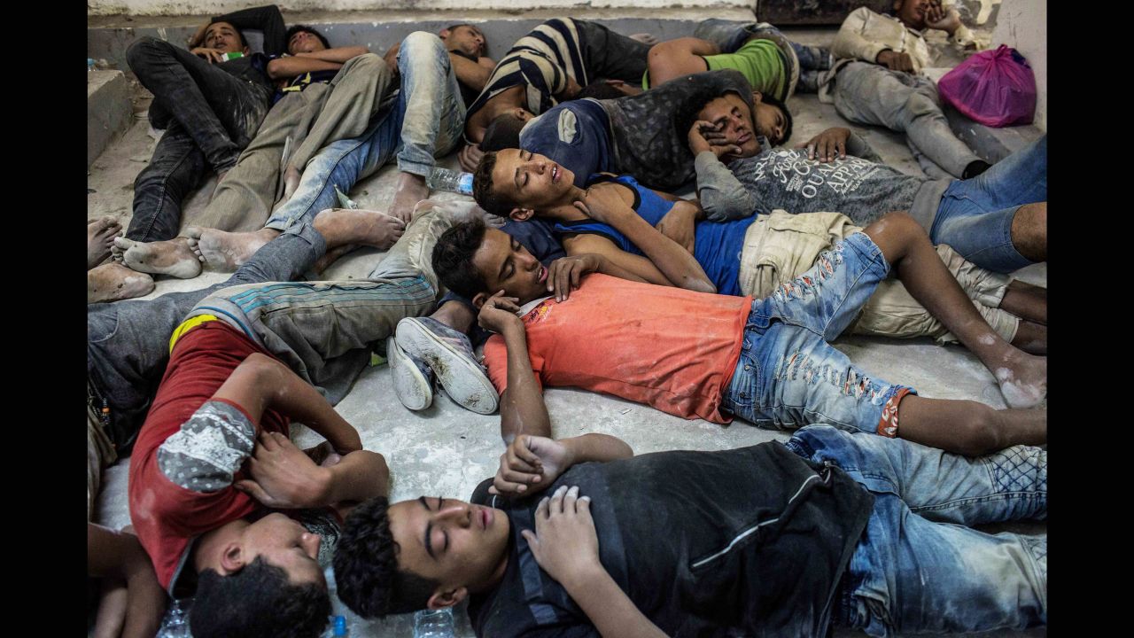 Survivors of a boat that capsized in the Mediterranean on Wednesday sleep in an Egyptian police station.
