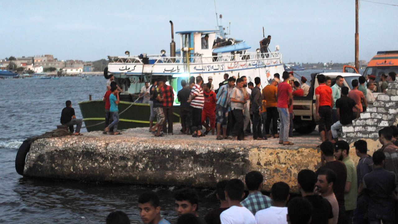 People gather at the port at Rashid.