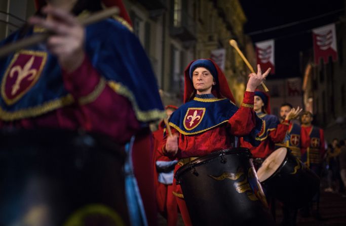 Performers in medieval costume parade through the streets at the Palio di Asti, an Italian festival dating back to the 13th century that culminates in a bareback horse race.
