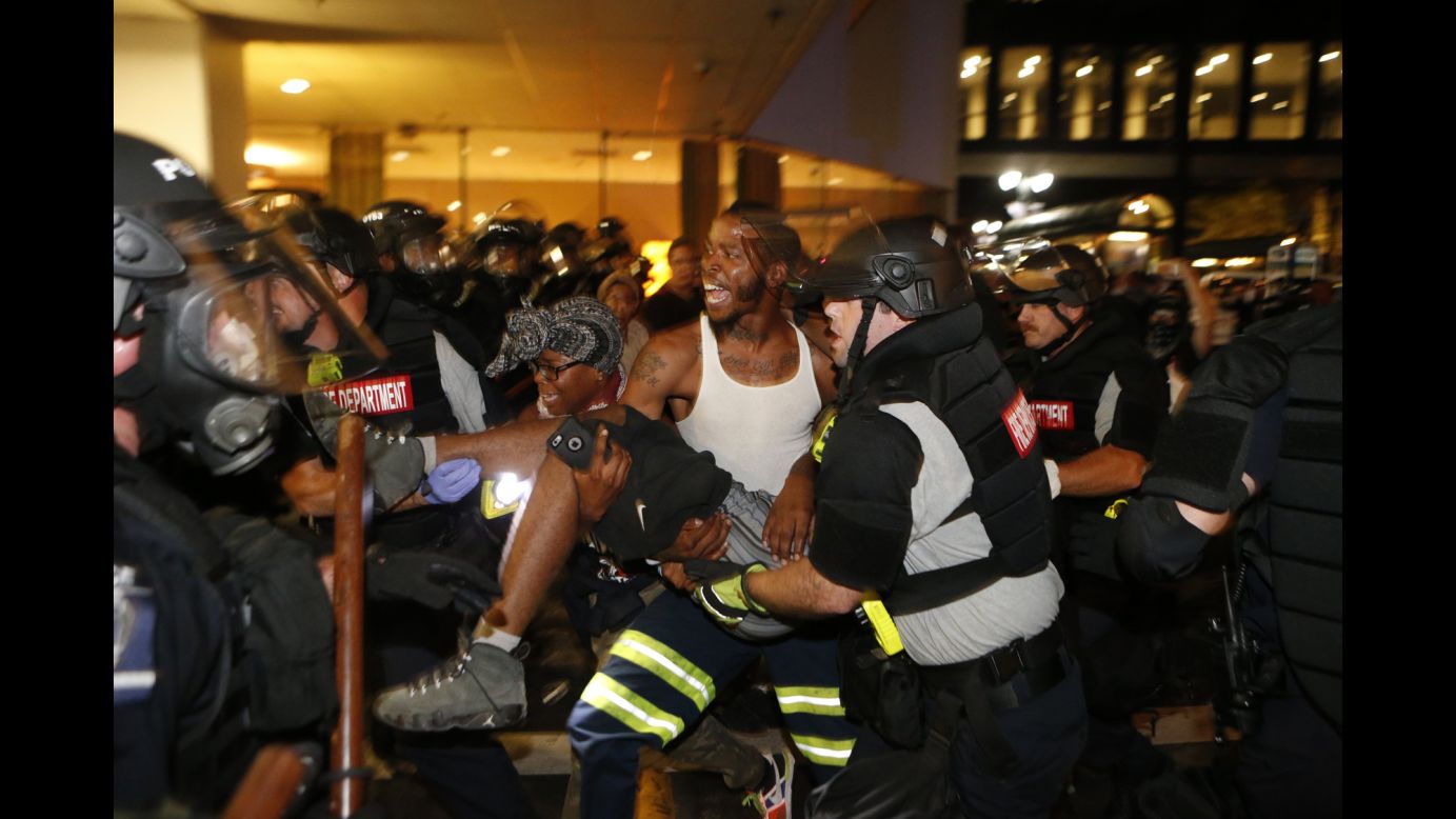 Police officers and protesters carry a man who was shot <a href="http://www.cnn.com/2016/09/21/us/charlotte-police-shooting/" target="_blank">during a second night of protests</a> in Charlotte, North Carolina, on Wednesday, September 21. The shooting victim, 26-year-old Justin Carr, later died. The city said he was shot by another civilian. <a href="http://www.cnn.com/2016/09/21/us/gallery/charlotte-protest/index.html" target="_blank">Violent protests erupted in Charlotte</a> following the death of Keith Lamont Scott, who was shot by police in an apartment complex parking lot. Charlotte-Mecklenburg Police Chief Kerr Putney said Scott exited his car with a gun and that he was shot after he wouldn't drop it. Scott's family said he was unarmed and sitting in his car reading a book.