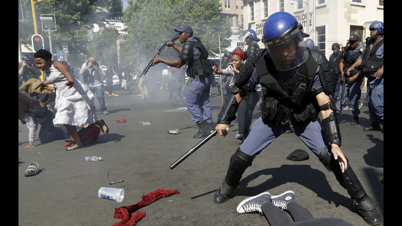 Student protesters in Johannesburg run for cover as police try to disperse them on Wednesday, September 21. Protests turned violent over an increase in South Africa's university fees.