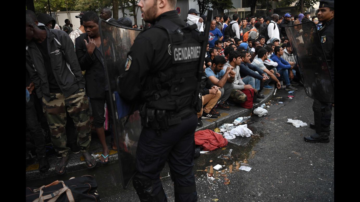 French gendarmes secure an area in Paris where a makeshift migrant camp was being dismantled on Friday, September 16. The migrants were moved to other shelters.