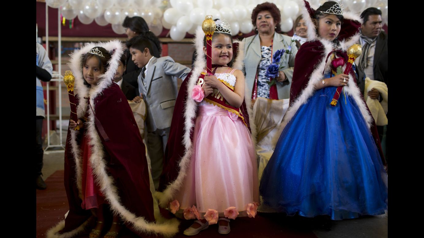 From left, Vanesa Huanca, Shanik Vera and Claudia Martinez wear capes after being crowned "Spring Queens" by their teachers in El Alto, Bolivia, on Wednesday, September 21. 