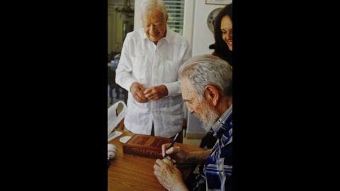 Fidel Castro signs a baseball for former US President Jimmy Carter in a photograph featured in Alex Castro's book on his father.