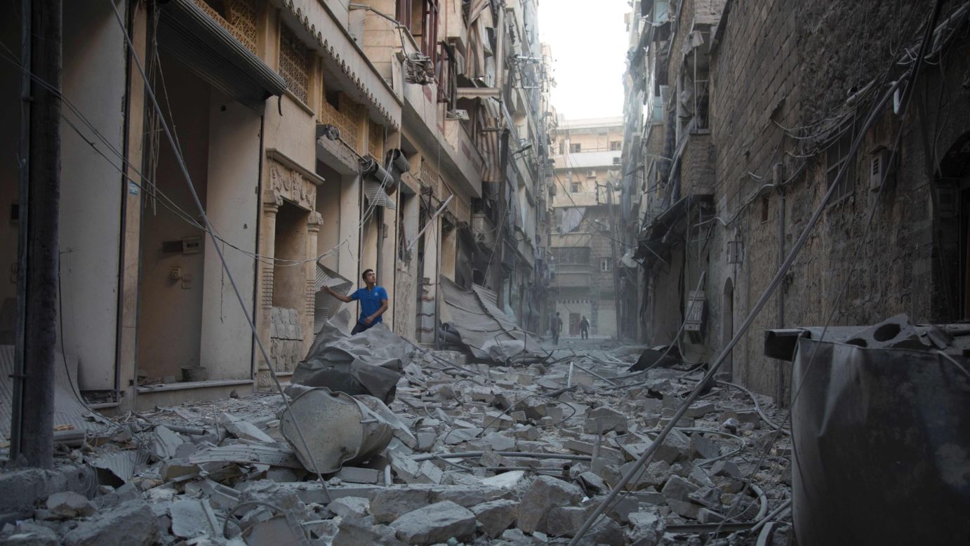 A man stands in the rubble of destroyed buildings following an airstrike in Aleppo, Syria, on Sunday, September 18.