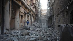 TOPSHOT - A Syrian man stands in the rubble of destroyed buildings following an air strike in Aleppo's rebel-controlled neighbourhood of Karm al-Jabal on September 18, 2016.Syria's ceasefire was on the brink of collapsing on September 18, after a US-led coalition strike killed dozens of regime soldiers and Aleppo city was hit by its first raids in nearly a week. / AFP PHOTO / KARAM AL-MASRIKARAM AL-MASRI/AFP/Getty Images