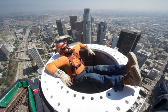 Construction worker at the Wilshire Grand Center takes a hair-raising break over 1,000 feet above Los Angeles.  