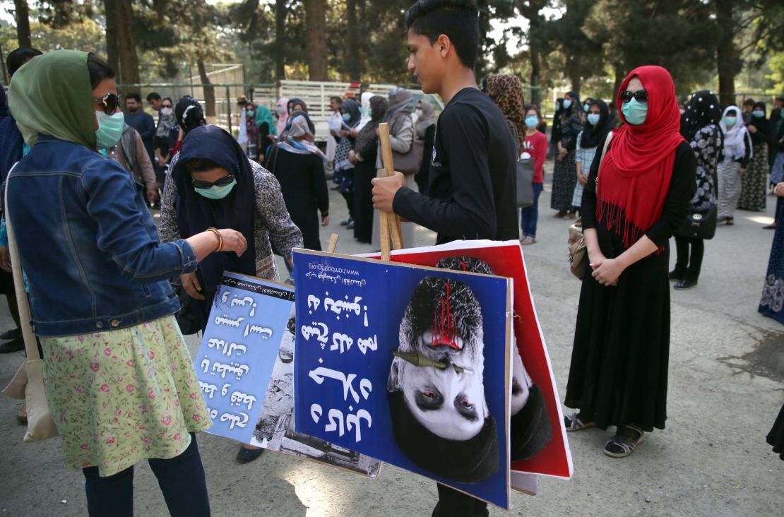 An Afghan demonstrator holds placards of Gulbuddin Hekmatya,during a demonstration in a public park in Kabul.