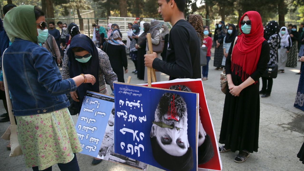 An Afghan demonstrator holds placards of Gulbuddin Hekmatya,during a demonstration in a public park in Kabul.