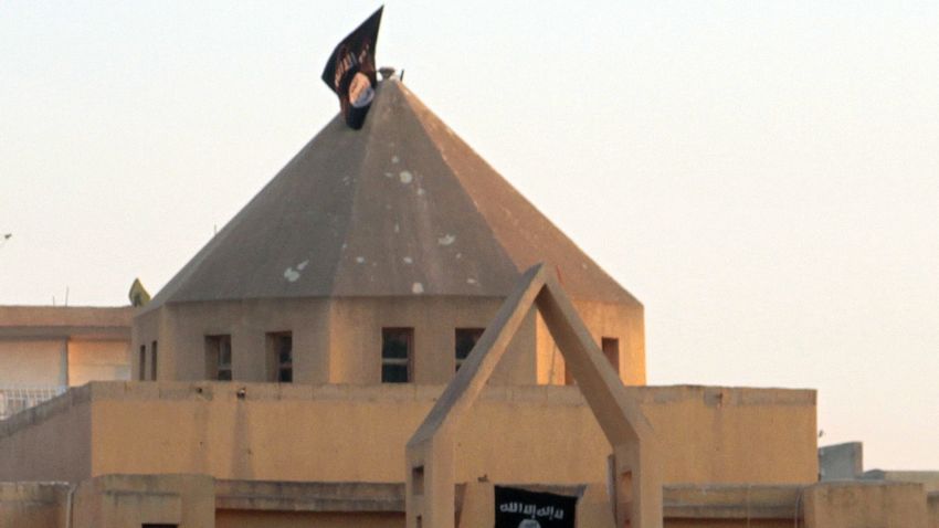 The flag of the Islamic State of Iraq and the Levant (ISIL) flutters on the "dome" of the  Armenian Catholic Church of the Martyrs in the northern rebel-held Syrian city of Raqqa on September 28, 2013.