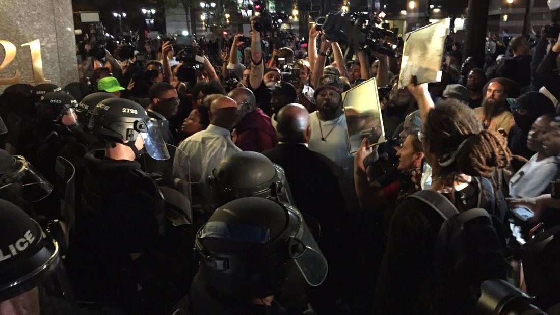 Protesters confront police officers near Trade and Tryon streets on September 22.