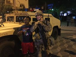 A protester joins a National Guardsman in Charlotte.