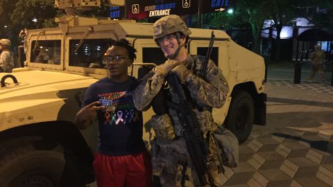 A protester joins a National Guardsman in Charlotte.